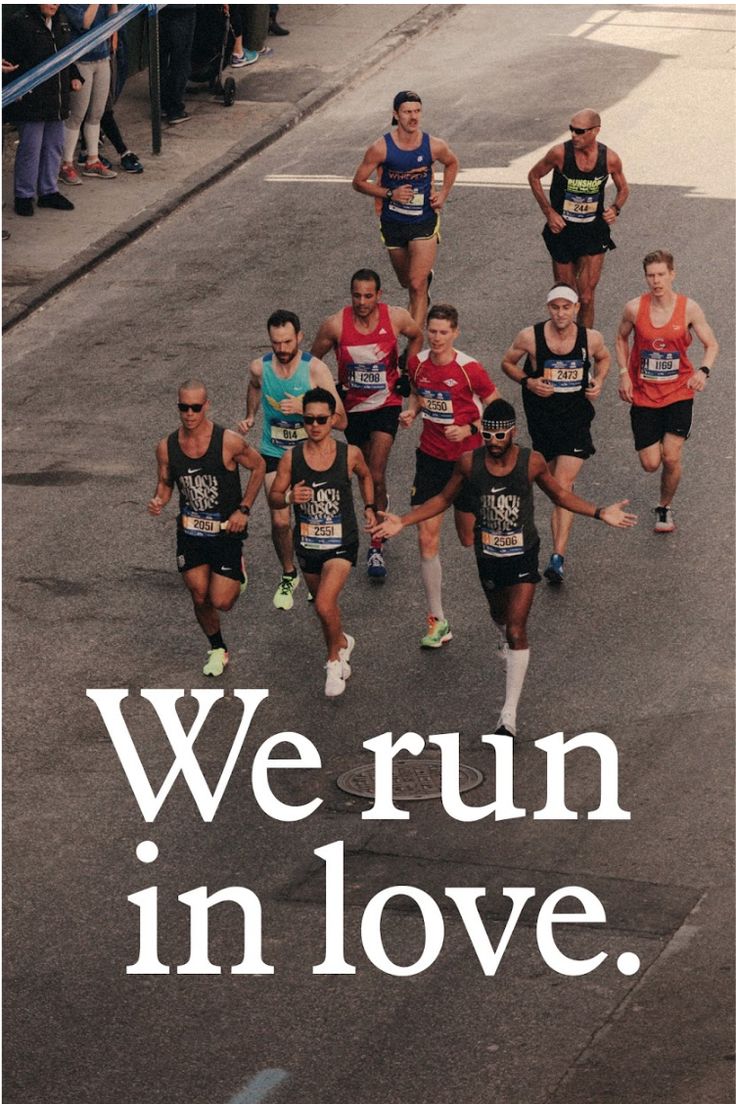 a group of people running down a street with the words we run in love