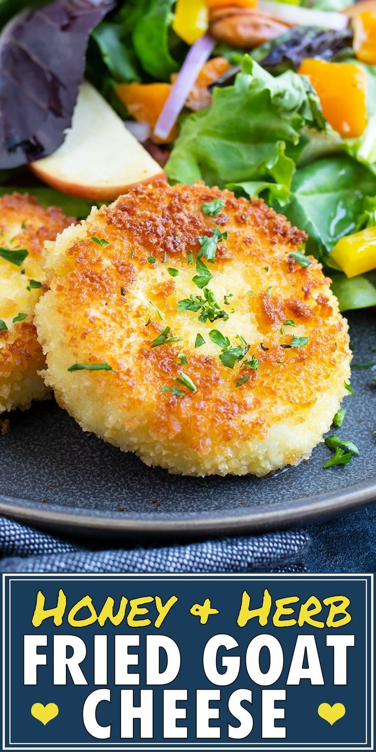 two fried goat cheese patties on a plate with salad