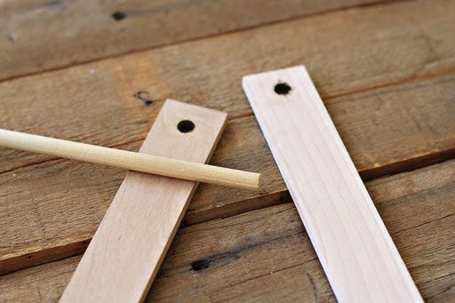 two pieces of wood sitting on top of a wooden floor next to a pair of chopsticks