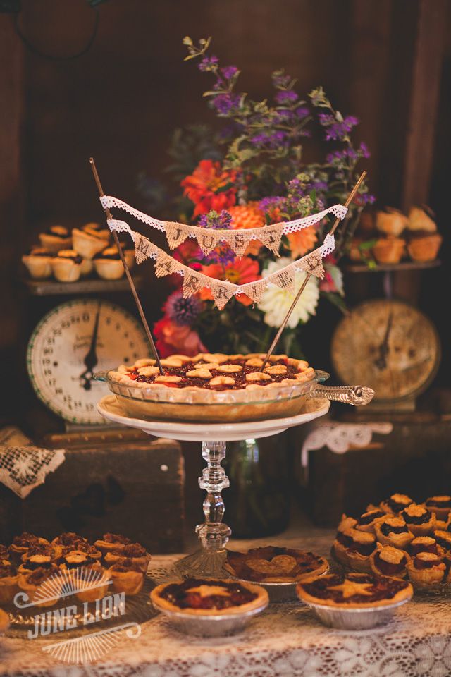 a table topped with pies and cupcakes