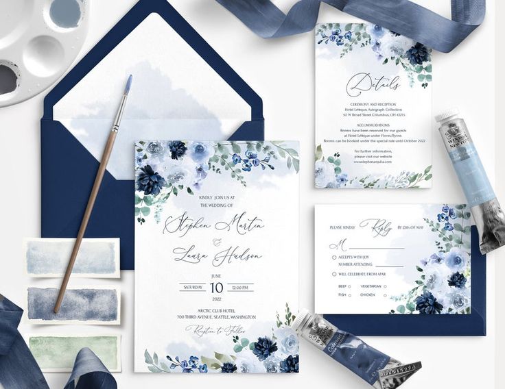 wedding stationery with blue and white flowers on it, including an envelope, watercolor paint