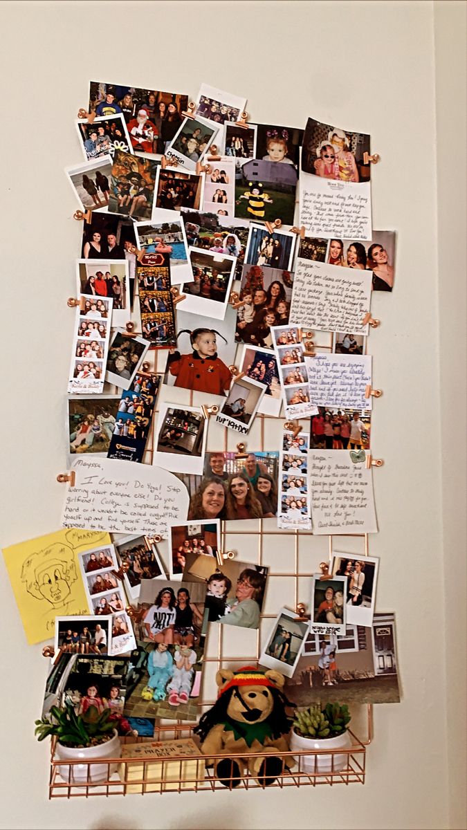 a collage of photos and pictures on a wall above a shelf with a teddy bear