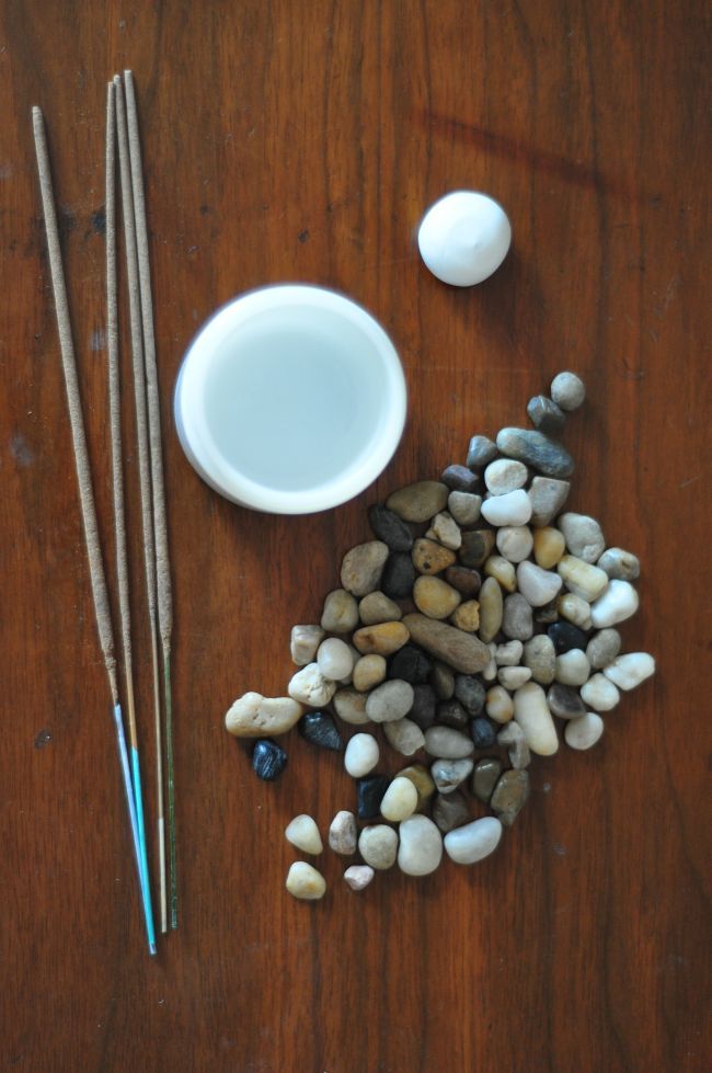 two chopsticks and some rocks on a table