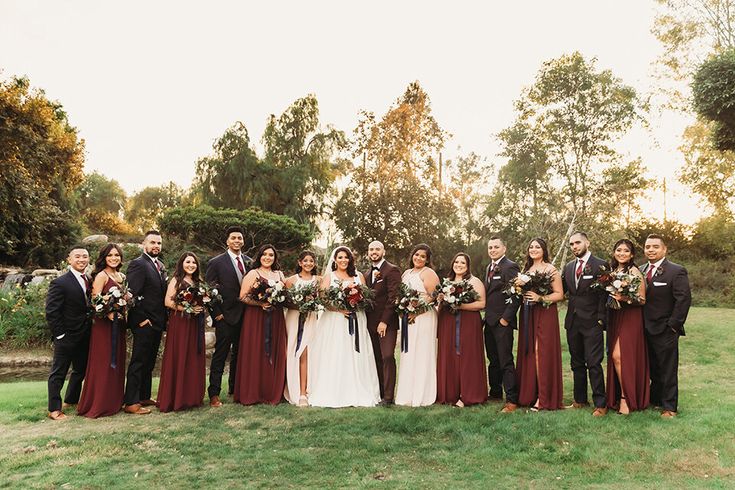 a group of people standing next to each other on top of a lush green field