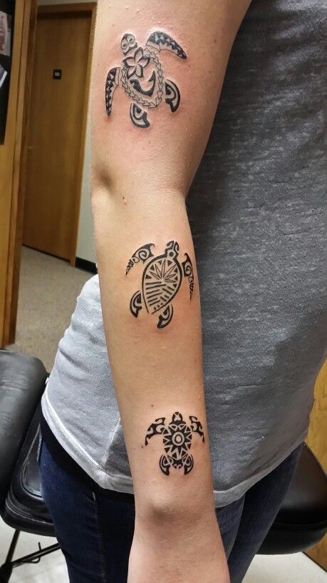 a woman's arm with two tattoos on it and a turtle in the middle