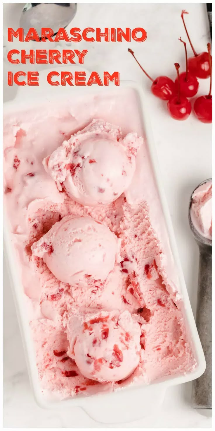 two scoops of cherry ice cream in a white dish with cherries on the side