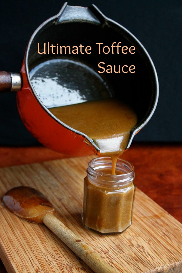 a wooden cutting board topped with an orange sauce