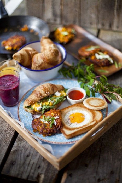 breakfast is served on a tray with croissants and juice