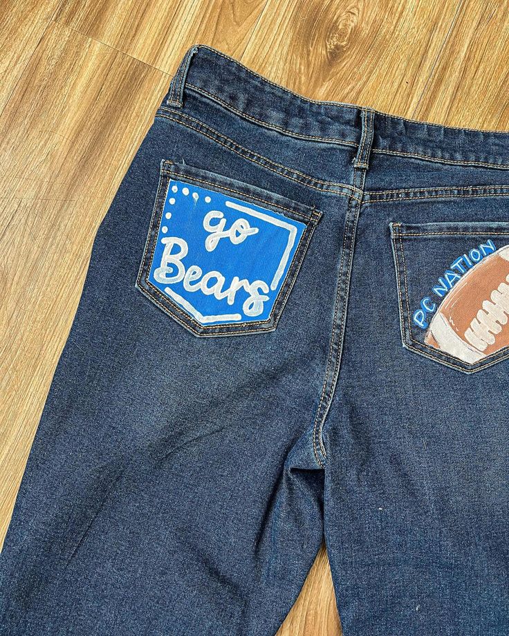 Looking for painted jeans? I am now doing customizable jeans!🩵🫶🏼🤪 #jeans #paintedjeans #art #paint #seniorjeans #smallbusiness Homecoming Painted Jeans Ideas Diy, Painting Jeans For Homecoming, Painted Jeans For Football Games, School Jeans Painted, Homecoming Painted Jeans, Hoco Painted Jeans, Homecoming Jeans Painted, Painted Jeans School Spirit, Hoco Jeans Painted