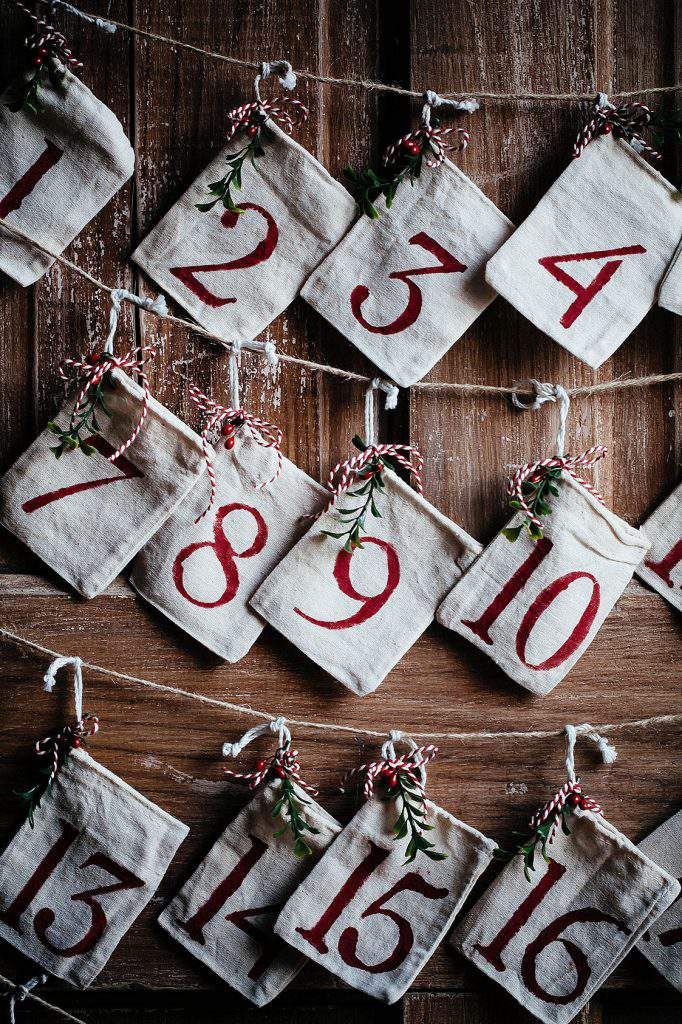 the numbers are hung on strings with christmas decorations hanging from it's sides and tied together