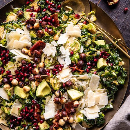 a salad with avocado, pomegranate and other vegetables