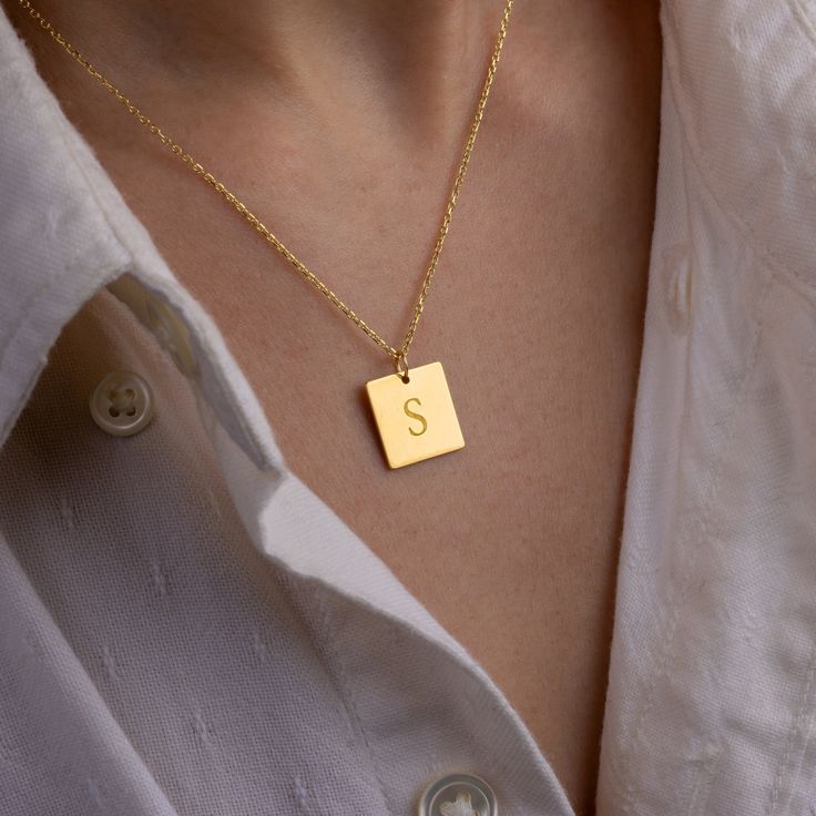 Stylish and minimalist 14K gold personalized square initial necklace for everyday wear. Great for layering.  Unique personalized gift idea to show love to the important people in your life with a cute, dainty, and creative gift. Customized rectangle tag necklace makes a perfect birthday gift for mothers, friends or yourself.  A special anniversary gift for significant others. Just engrave his/her name. It is a perfect gift. It can be dressed up or dressed down depending on the situation. We only Personalized Yellow Gold Charm Necklaces With Square Pendant, Yellow Gold Square Pendant Necklace For Personalized Gift, Personalized Yellow Gold Necklace With Square Pendant, Personalized Yellow Gold Square Pendant Necklace, Personalized Square Pendant Charm Necklaces In Yellow Gold, Minimalist Initial Pendant Necklace As Anniversary Gift, Minimalist Initial Pendant Necklace For Anniversary Gift, Simple Rectangular Jewelry For Anniversary, Everyday Personalized Square Pendant Necklaces