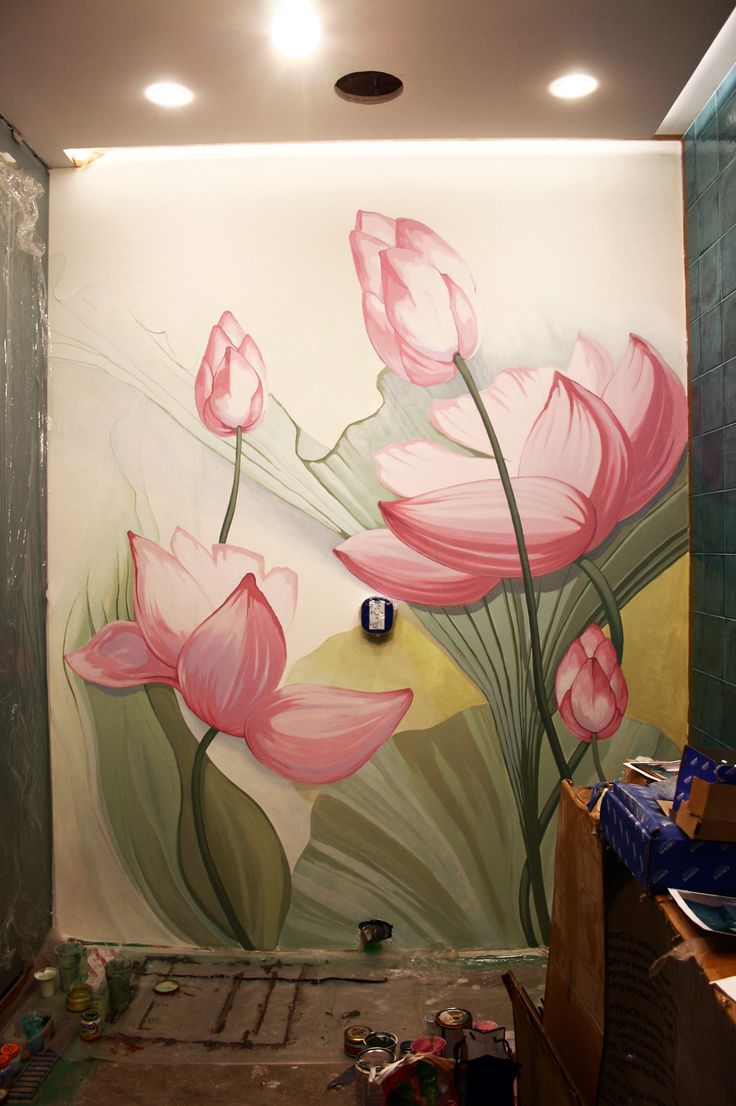 a painting on the wall of a bathroom with pink flowers painted on it's walls