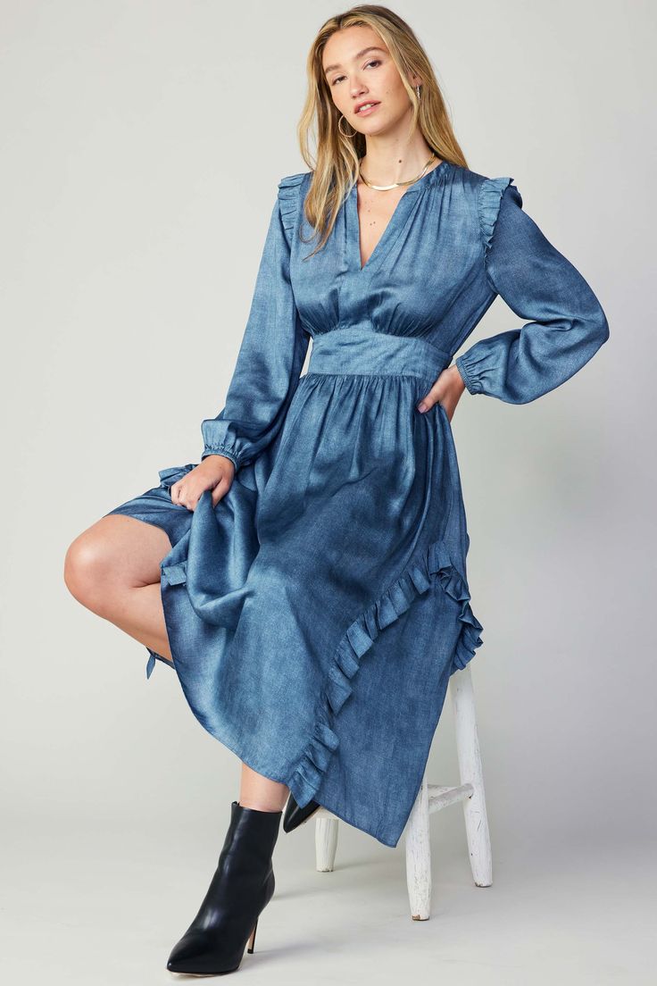 Accented by ruffle trim at the shoulders and skirt, this long-sleeve midi dress is one of those styles you'll wear in any season. It's feminine and flattering, designed with a split neckline, a clean placket, and a gathered bodice drawn in by smocking at the back waist. All finished with denim-like print utilizing Trom Brunch Midi Dress With Ruffle Hem, Spring Midi Length Ruffle Dress, Chic Long Sleeve Ruffle Dress For Brunch, Chic Spring Long Sleeve Dress With Ruffle Hem, Chic Long Sleeve Dress With Ruffle Hem For Spring, Fall Ruffle Midi Length Dress, Fall Ruffle Midi Dress, Long Sleeve Midi Dress With Ruffles For Spring, Knee-length Long Sleeve Ruffled Dress For Spring