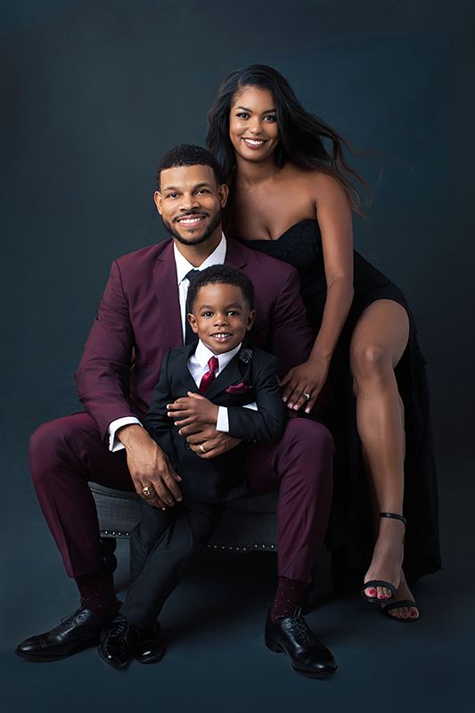 a man, woman and child posing for a photo