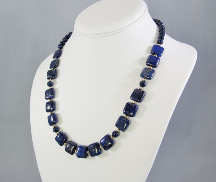 "Uniquely cut square \"pillows\" of vibrant blue lapis lazuli spaced with 14K gold filled beads create this beautiful adjustable length necklace. Two sizes are available, each with a 2 inch gold filled chain so every woman can get their best fit. The 12 mm squares are large enough to showcase the beauty of the natural stone, yet small enough for an everyday fashion accessory. Choose from 16 to 18 inch and 20 to 22 inch, that's 41-46 cm or 51-56 cm for my non-US visitors. Or send me a message to Rectangular Lapis Lazuli Jewelry As Gift, Blue Beaded Rectangular Jewelry, Blue Rectangular Beaded Jewelry, Adjustable Blue Square Pendant Jewelry, Rectangular Blue Necklace With Natural Stones, Blue Lapis Lazuli Rectangular Jewelry, Blue Rectangular Jewelry With Natural Stones, Blue Rectangular Natural Stones Jewelry, Blue Rectangular Natural Stone Necklace