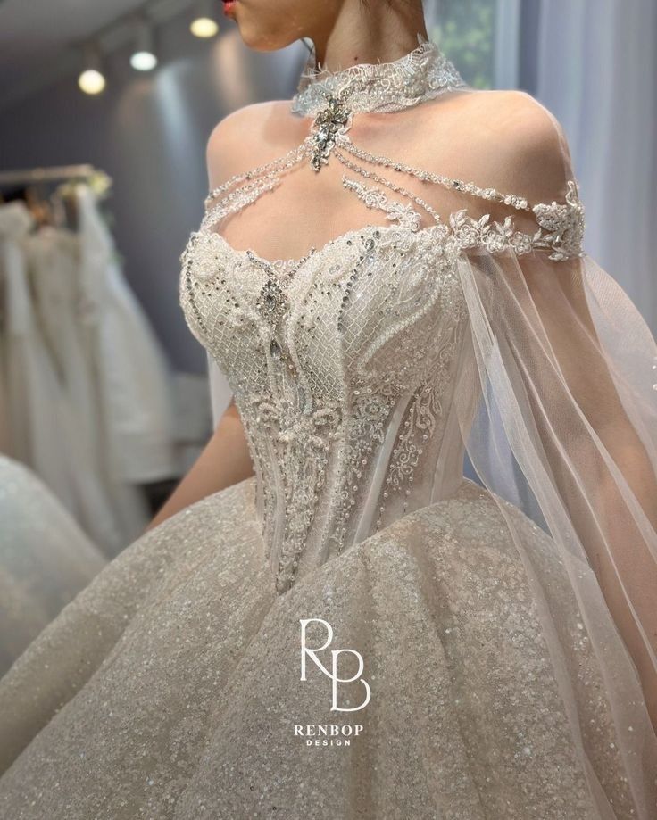 a woman in a wedding dress looking at herself