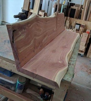 a wooden bench sitting on top of a table in a room filled with lots of wood