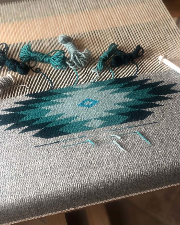 the table is covered with yarn and crochet hooks on it's sides