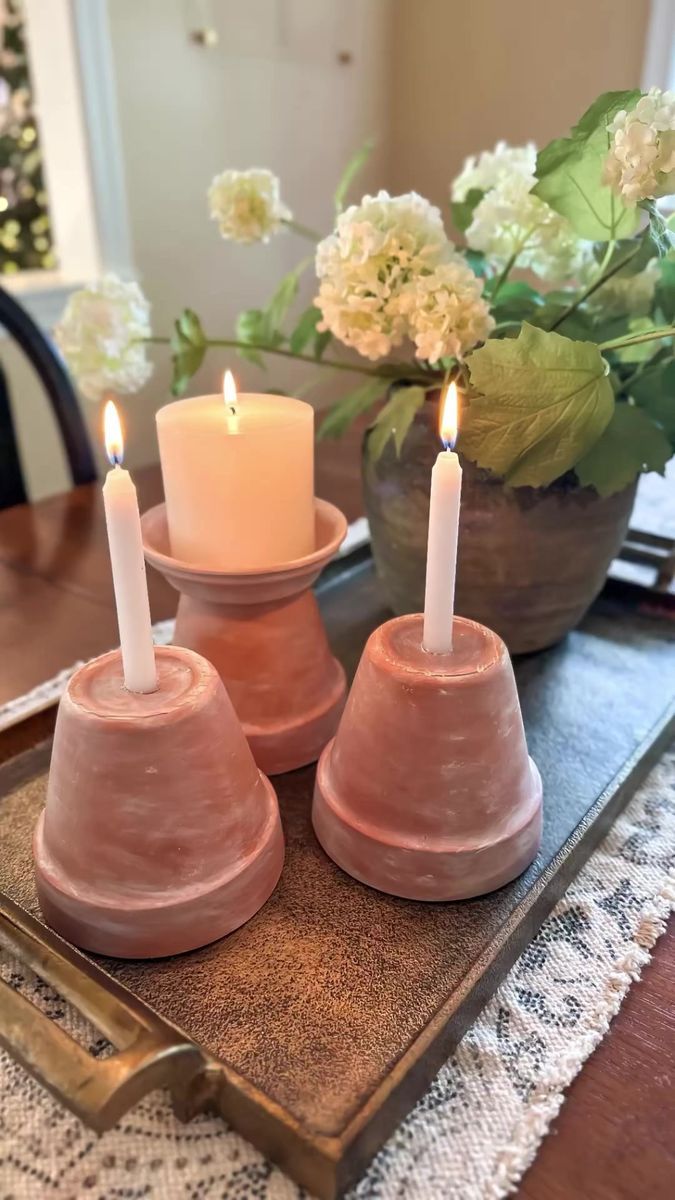 three candles sitting on top of a tray