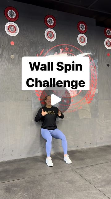 a woman standing in front of a wall with the words wall spin challenge on it