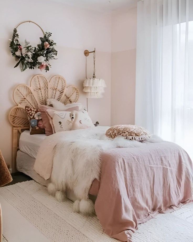 a bedroom with pink walls and white bedding, decorated in wicker headboard