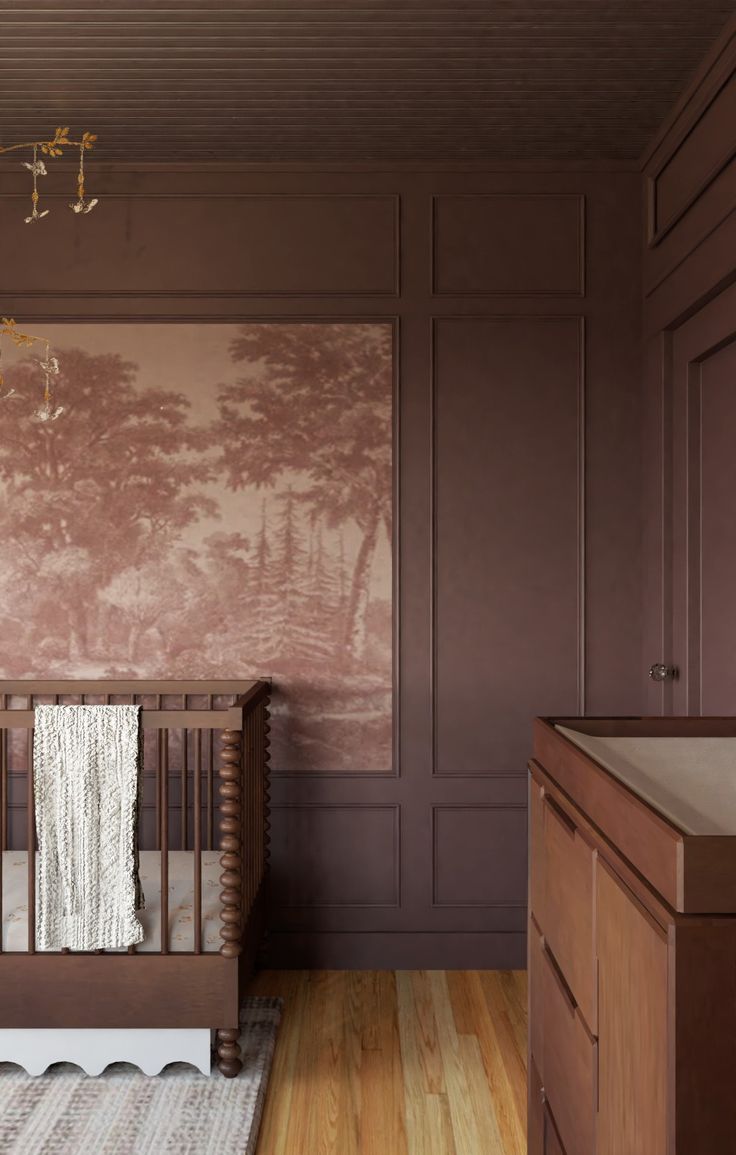 a baby's crib in the corner of a room with pink wallpaper