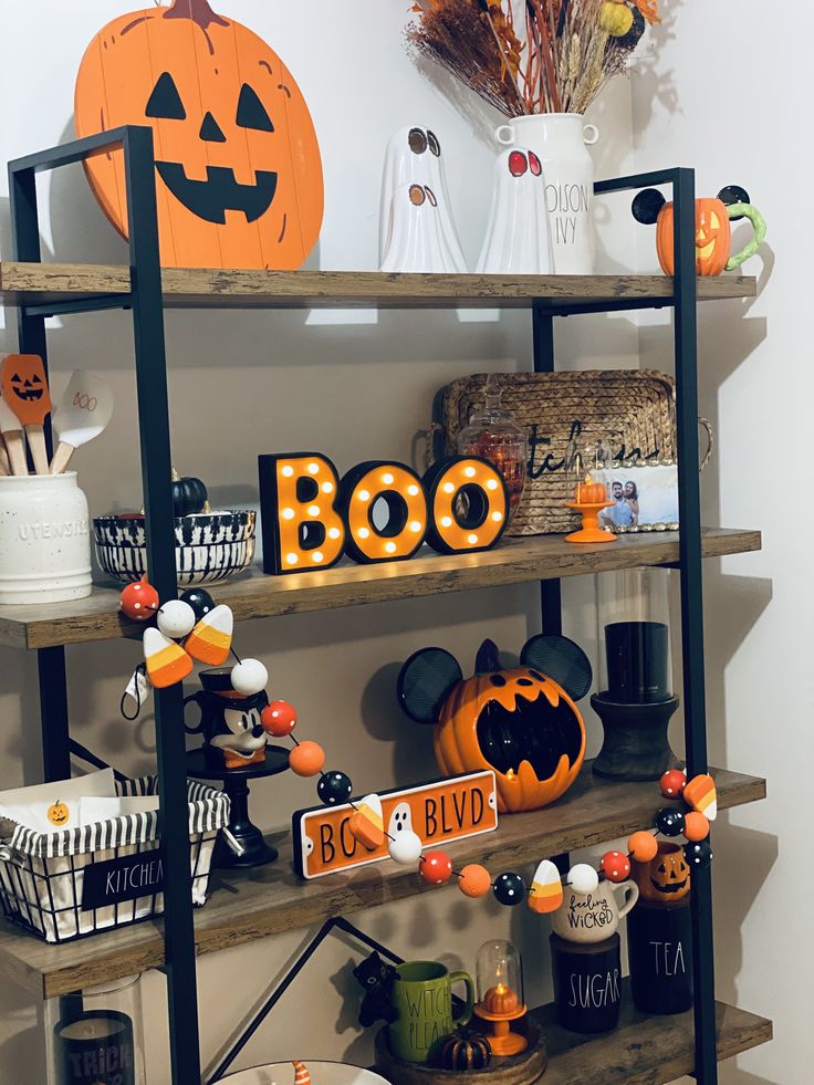 halloween decorations are displayed on shelves in a room