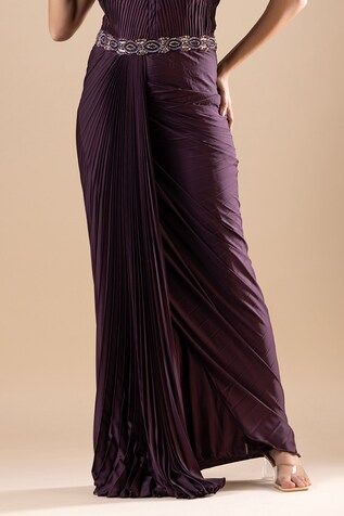 Wine pleated armani satin draped saree gown with crystals, cutdana, Swarovski, and sequins hand embroidery. Comes with a detachable palla. - Aza Fashions Luxury Satin Pre-draped Saree With Cutdana, Draped Evening Dress With Ruched Bodice, Pre-draped Cocktail Evening Dress With Folds, Formal Ruched Draped Skirt, Wedding Evening Dress With Pleated Back And Draped Shape, Floor-length Wedding Dresses With Folds, Ruched Draped Gown For Gala, Pleated Draped Evening Dress, Draped Evening Dress With Folds