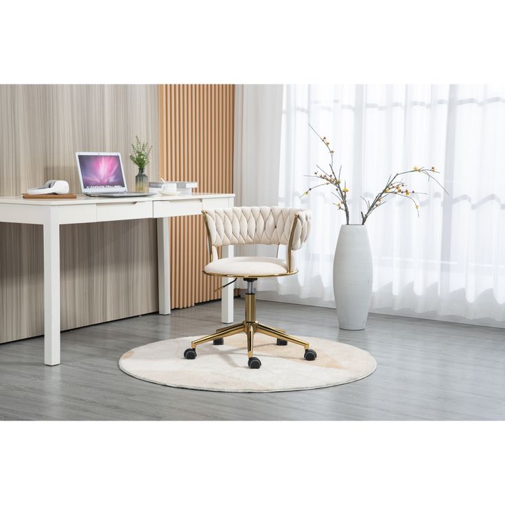 a white desk with a laptop computer on it and a chair in front of it