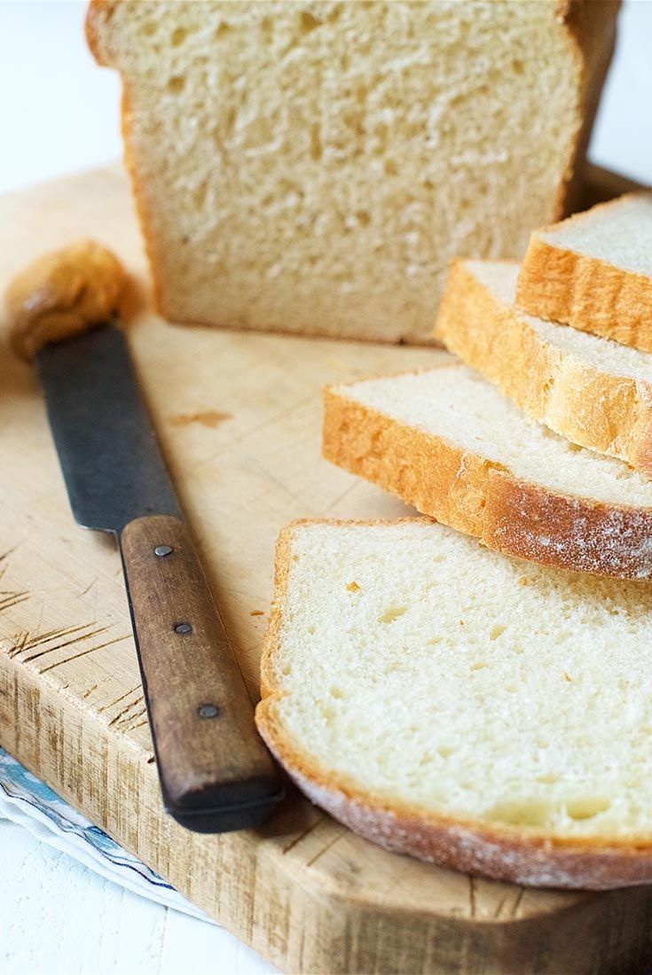 slices of bread on a cutting board next to a knife