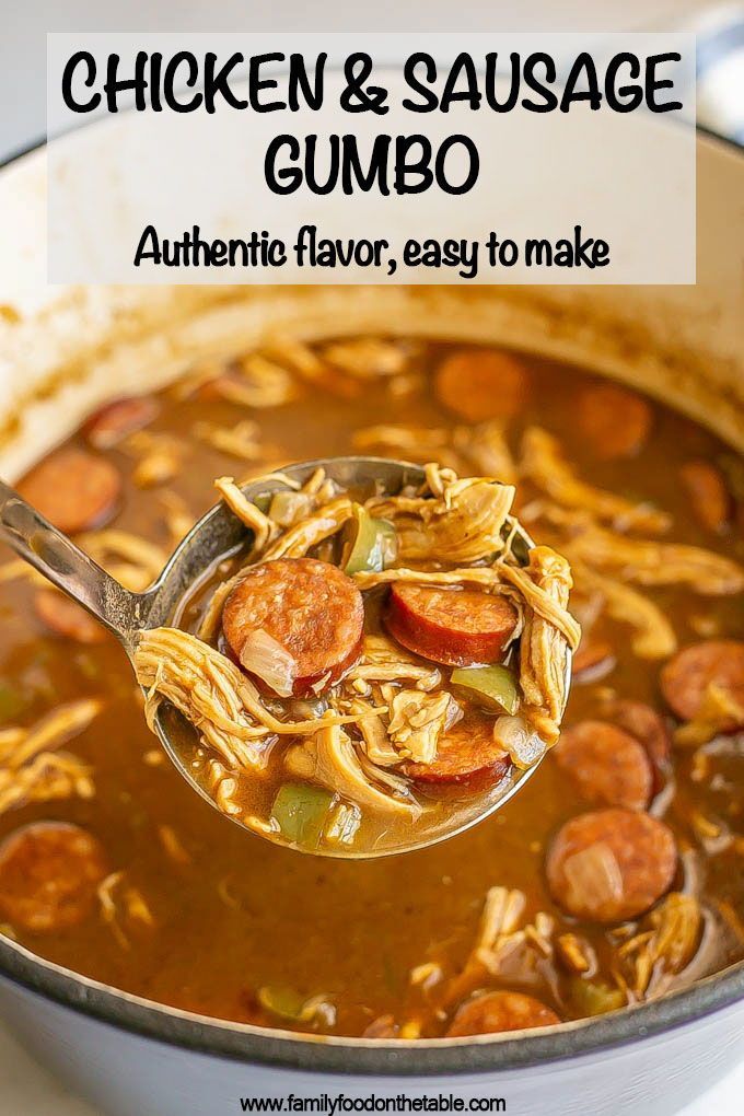 a ladle full of chicken and sausage gumbo is being held by a spoon