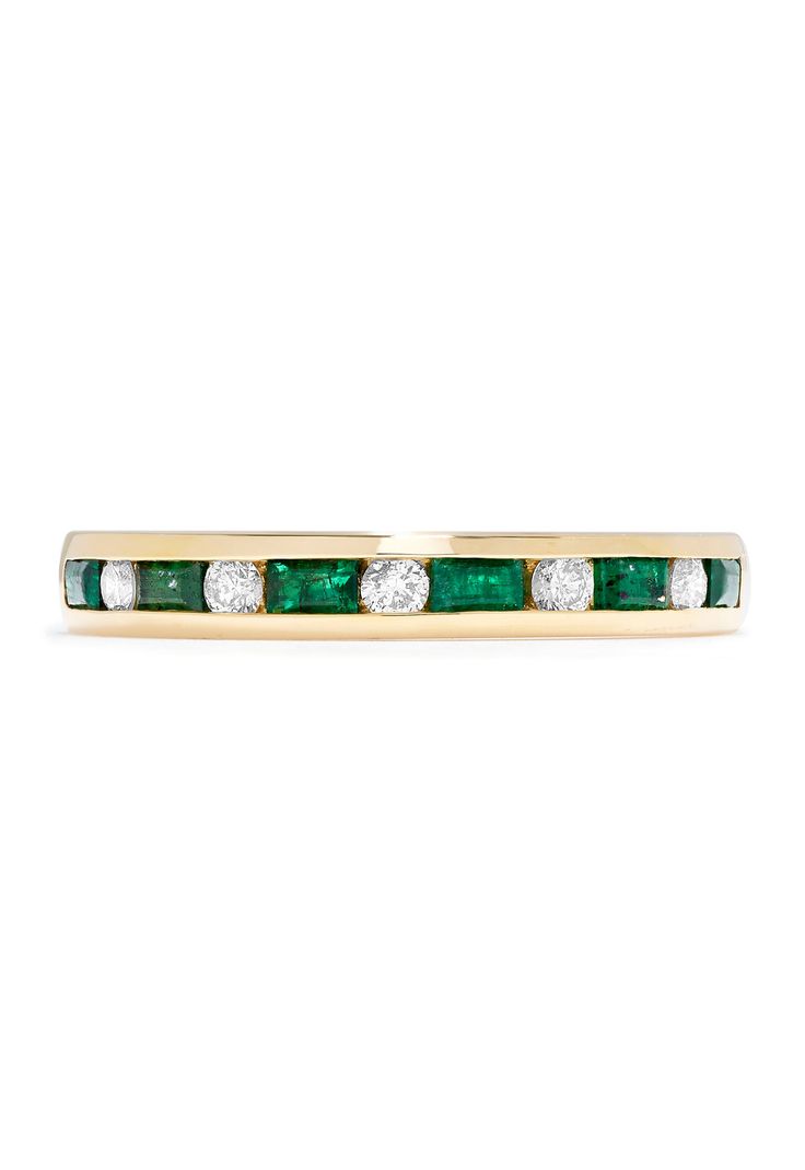 an emerald and diamond ring in yellow gold