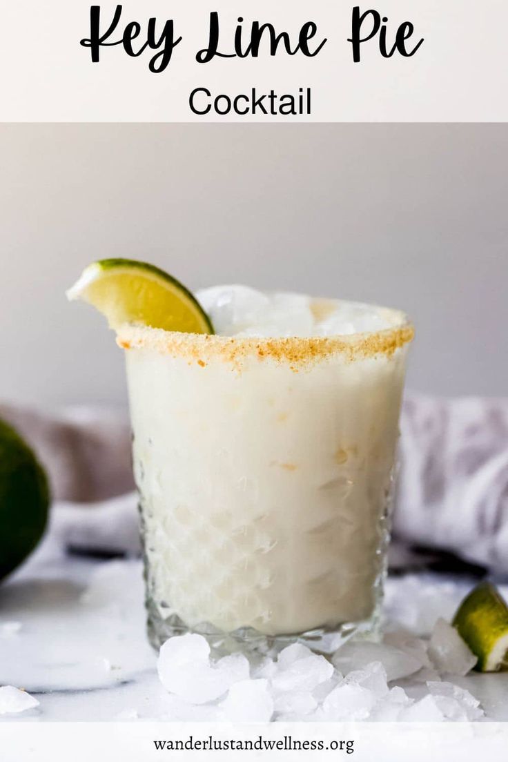 the key lime pie cocktail is garnished with sugar and limes