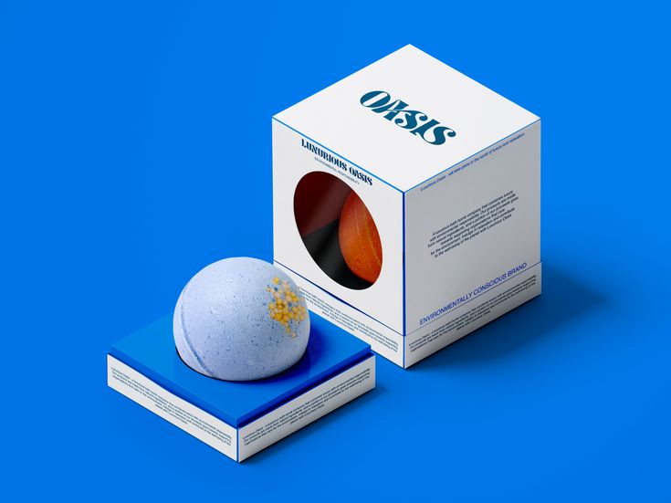 a white box sitting on top of a blue surface next to an orange and black object