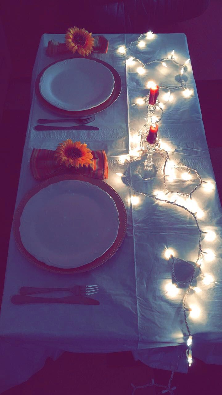 the table is set with plates and candles