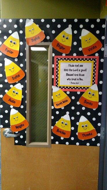 a classroom door decorated with paper cutouts and writing on the doors for halloween decorations