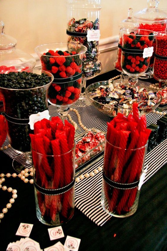 a table topped with lots of red and black candies