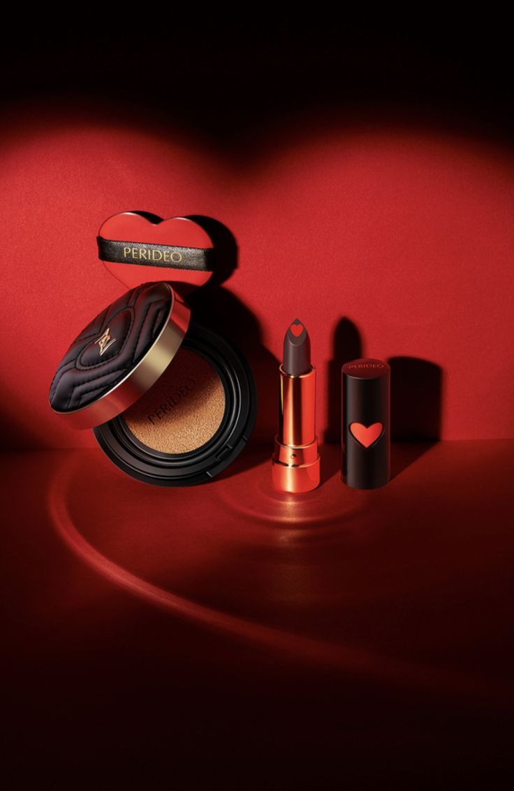 the mac cosmetics collection is displayed on a red surface, including lipstick and eyeliners