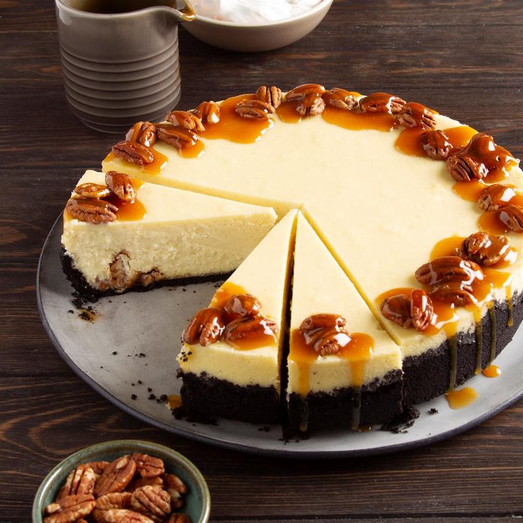 a cheesecake with pecans on the side