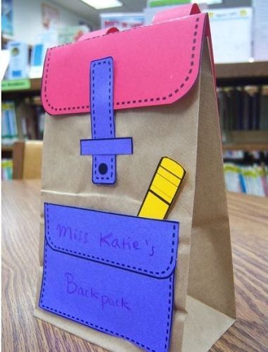 a brown paper bag with a purple and yellow design on it sitting on top of a wooden table