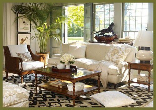 a living room filled with lots of white furniture