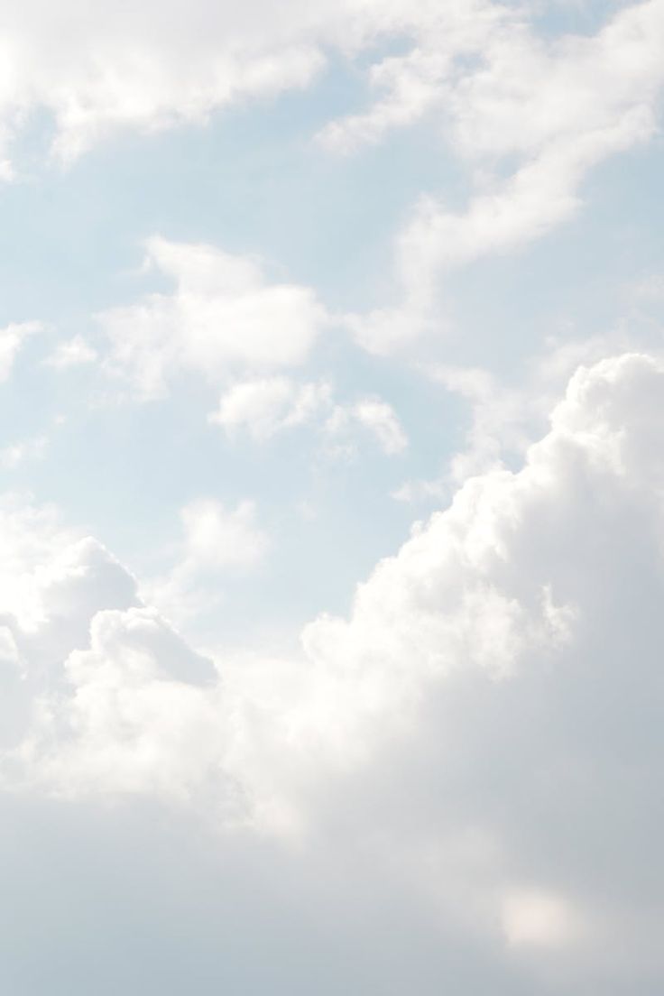 the airplane is flying high in the sky with some clouds behind it and one plane has just taken off