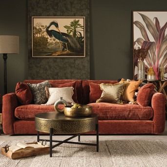 a living room filled with lots of furniture and paintings on the wall above it's coffee table