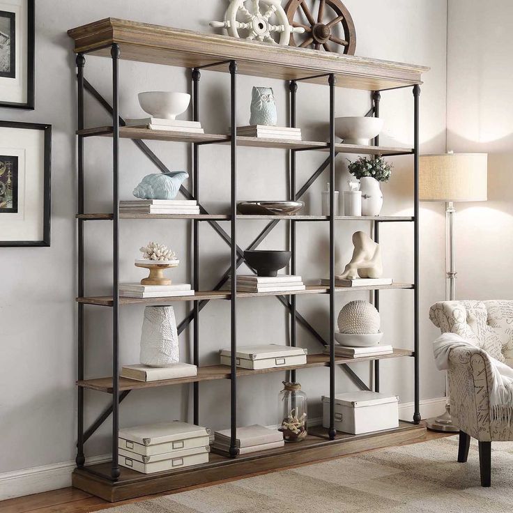 a living room filled with furniture and lots of bookshelves in front of a wall