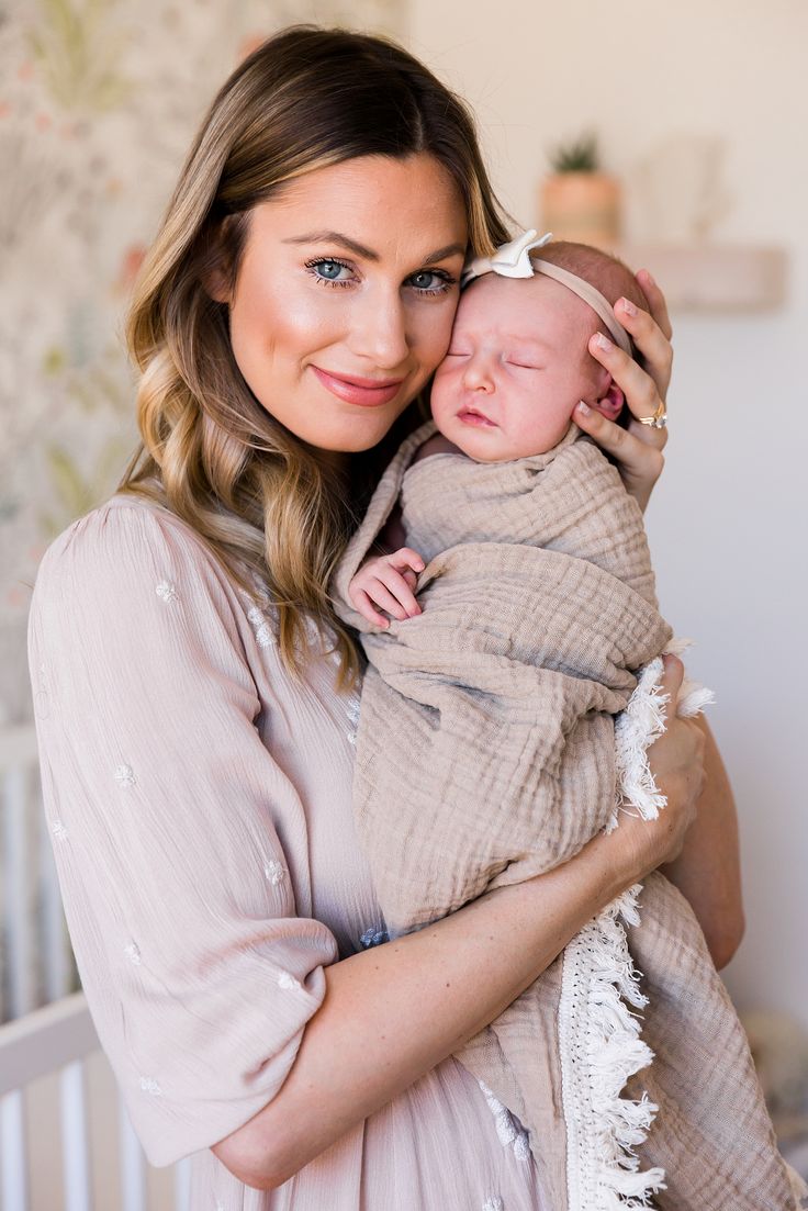 a woman holding a baby in her arms