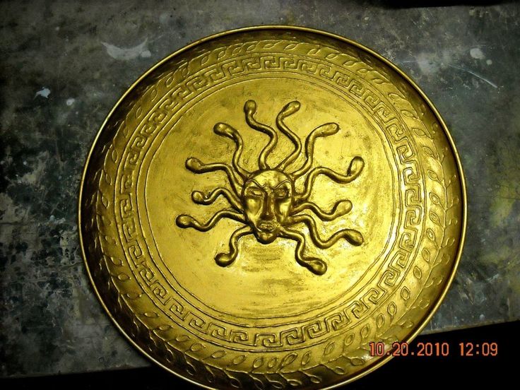 a gold plate with an intricate design on it