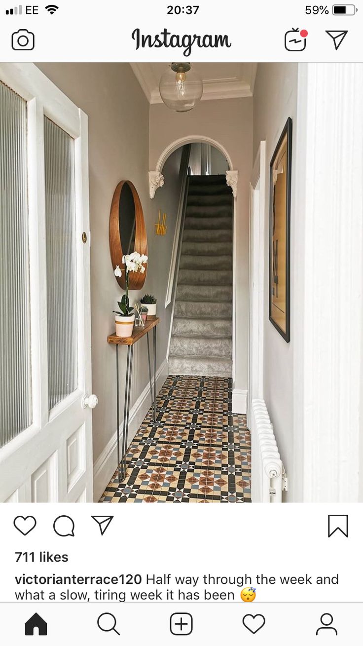 a hallway with tiled floors and white walls