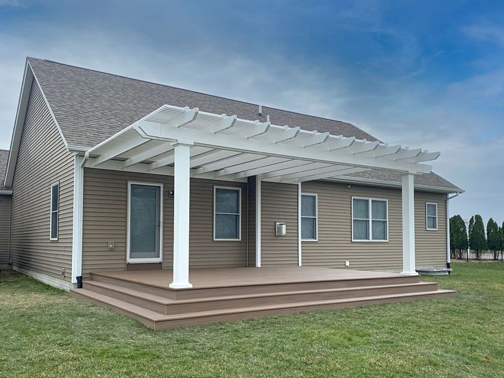 a small house with a covered porch in the front yard and grass on both sides