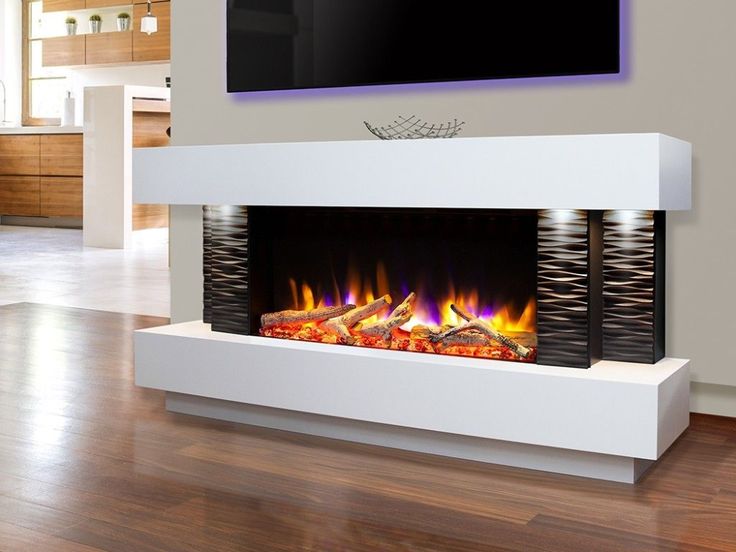 a modern fireplace in a living room with wood flooring and white wall mounted tv